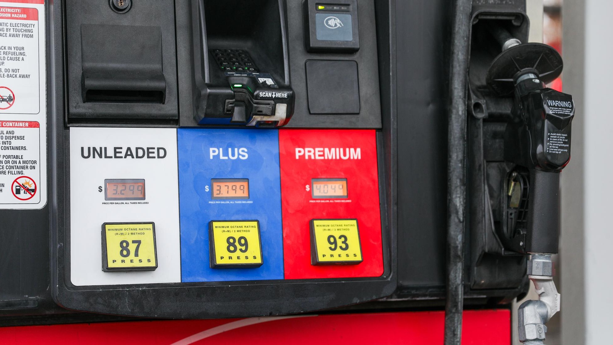 gas pump nozzle with rising numbers on the display symbolizing inflation and escalating gas prices
