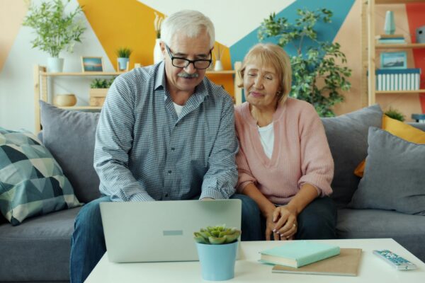 Elderly couple looking at a laptop together
