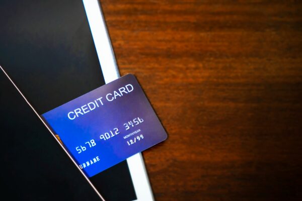 Credit card with mobile and tablet on wood table