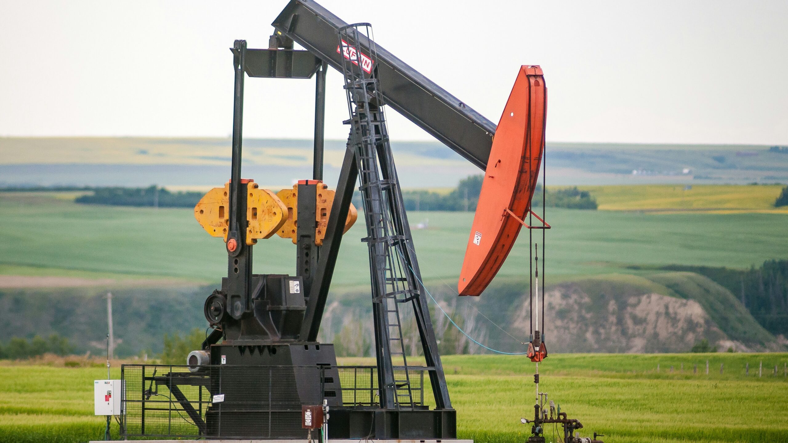 black and orange metal machine on green grass field during daytime