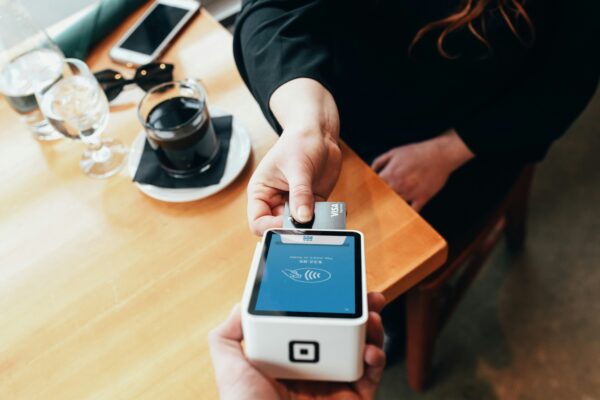 person holding credit card swipe machine
