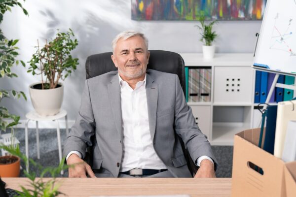 Sympathetic handsome older man boss manager of company