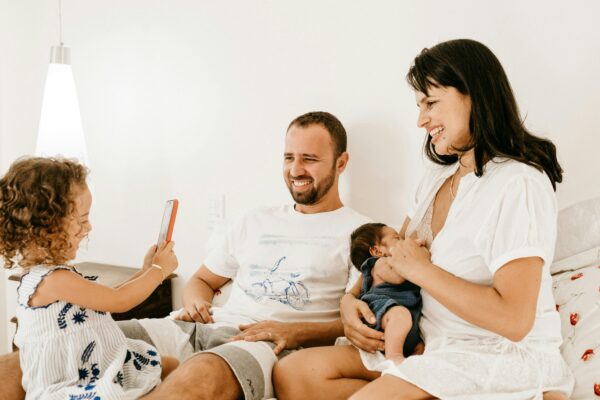 man in white crew neck t-shirt sitting beside woman in white crew neck t-shirt