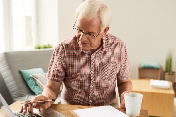 Senior Man Working with Laptop at Home