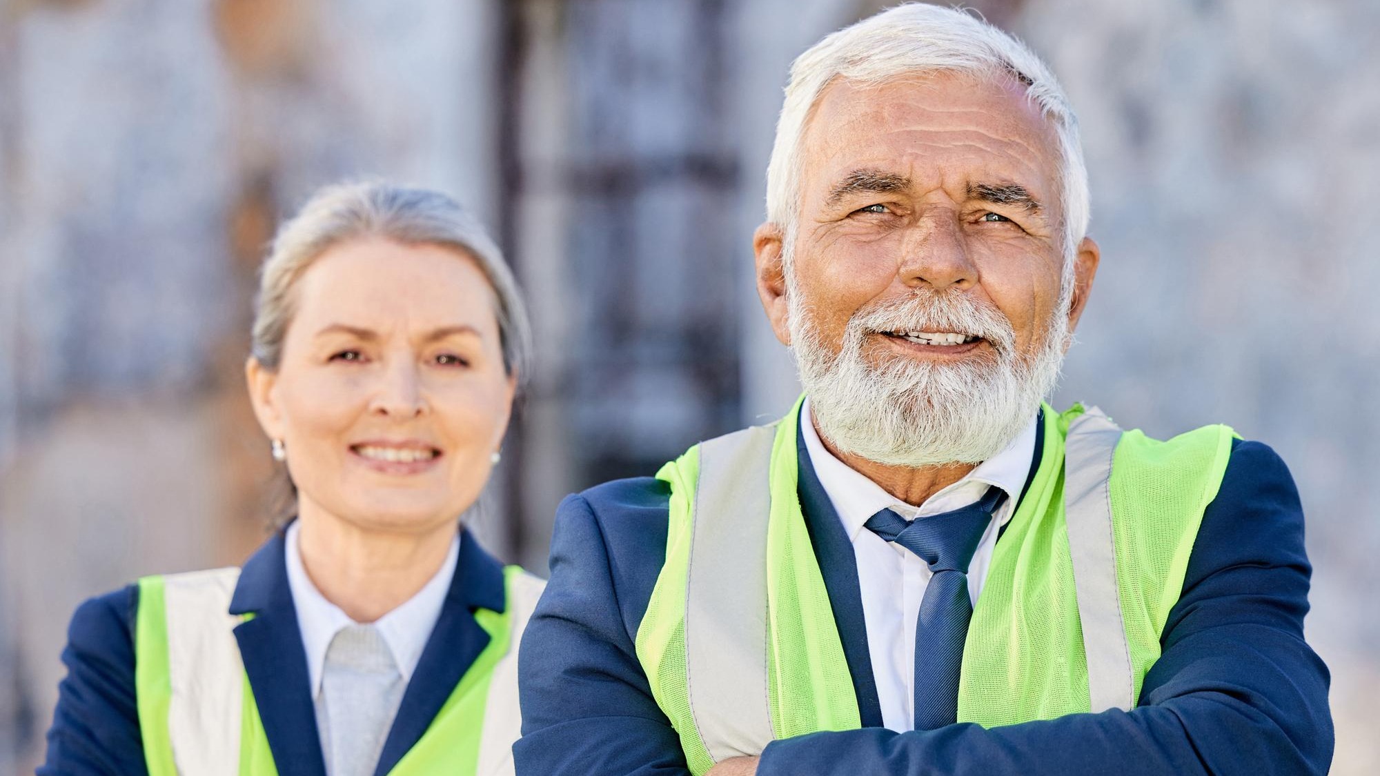 Mature team and arms crossed in portrait on construction site with supervisor or foreman in vest Manager boss and confidence for company with architect or city planner for collaboration in Germany