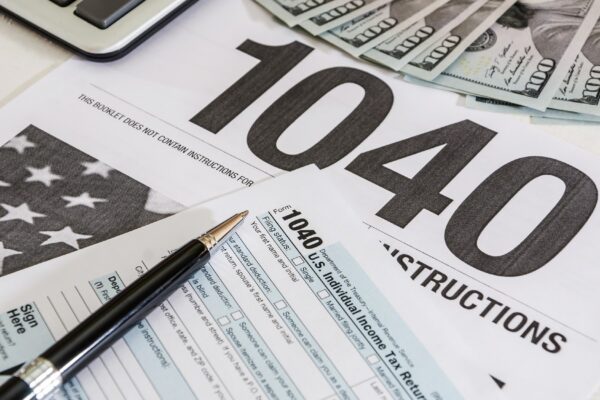 tax forms 1040 and calculator with dollars