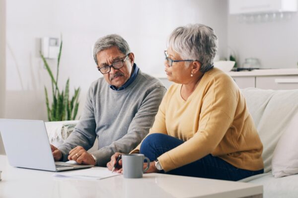 Home laptop and old couple with financial planning documents and life insurance Pensioner savings and man with woman computer and investment with retirement fund debt review or email with taxes