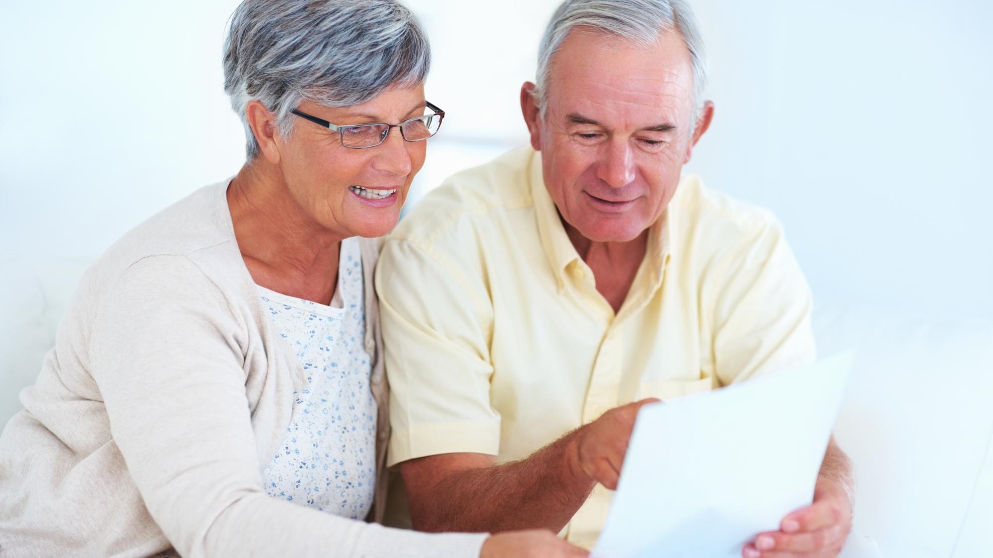 Home senior couple and budget with document for finance track expenses and discussion with bill Communication man and woman with paper for checking savings and review investment in retirement