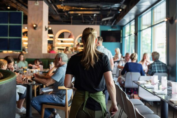 A group of people sitting at tables in a restaurant