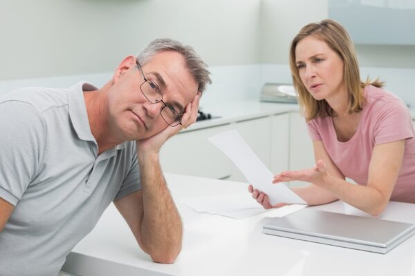Couple having an argument over a bill in kitchen