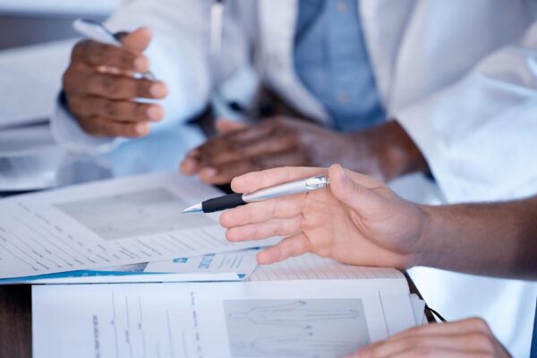 Doctors hands and paperwork of people for research healthcare planning and analysis Hospital staff medical documents and consulting in clinic team and expert advice of decision making results