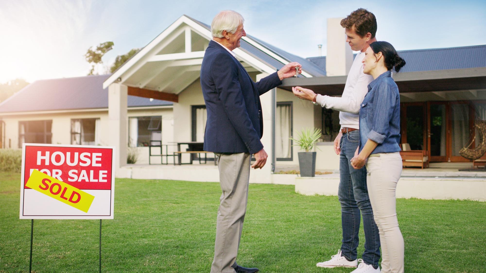 Couple real estate and realtor with keys to new home payment or mortgage loan on lawn outside Happy man and woman in relationship or homeowners with agent for buying property sale or sold house