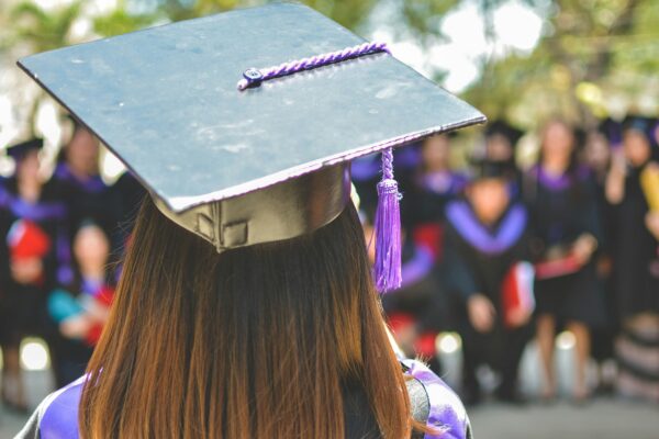 woman wearing academic cap and dress selective focus photography