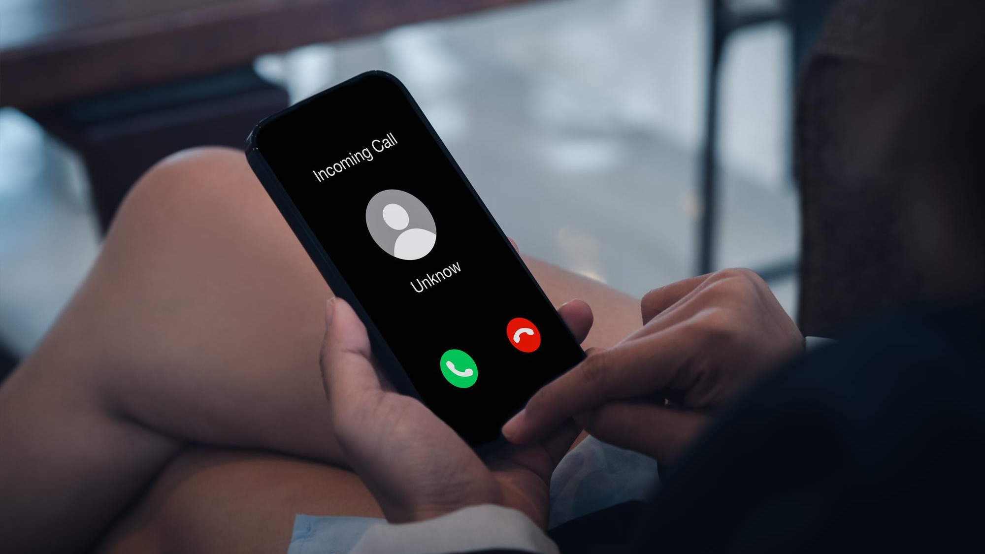 Incoming call with unknown caller malicious phone calls concept Unknown number displayed showing on smart mobile phone in business person hand Spam and robocalls scam call alert