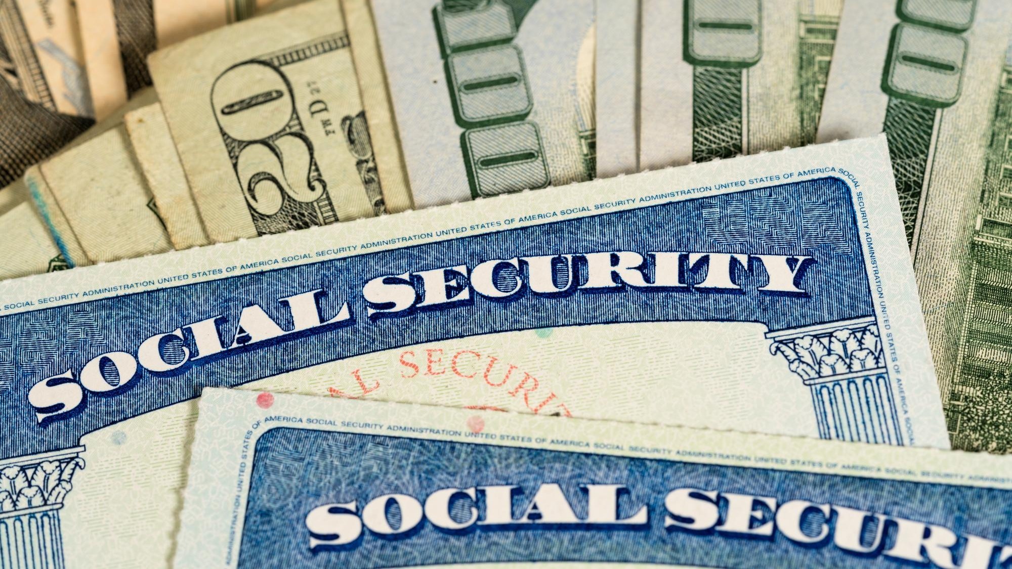 USA Social security cards laid on dollar bills