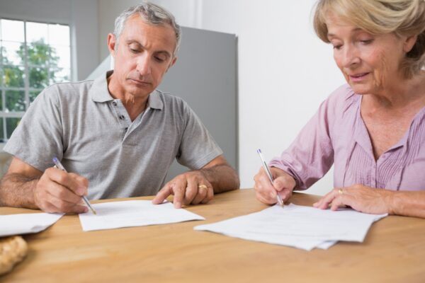 Couple signing documents together