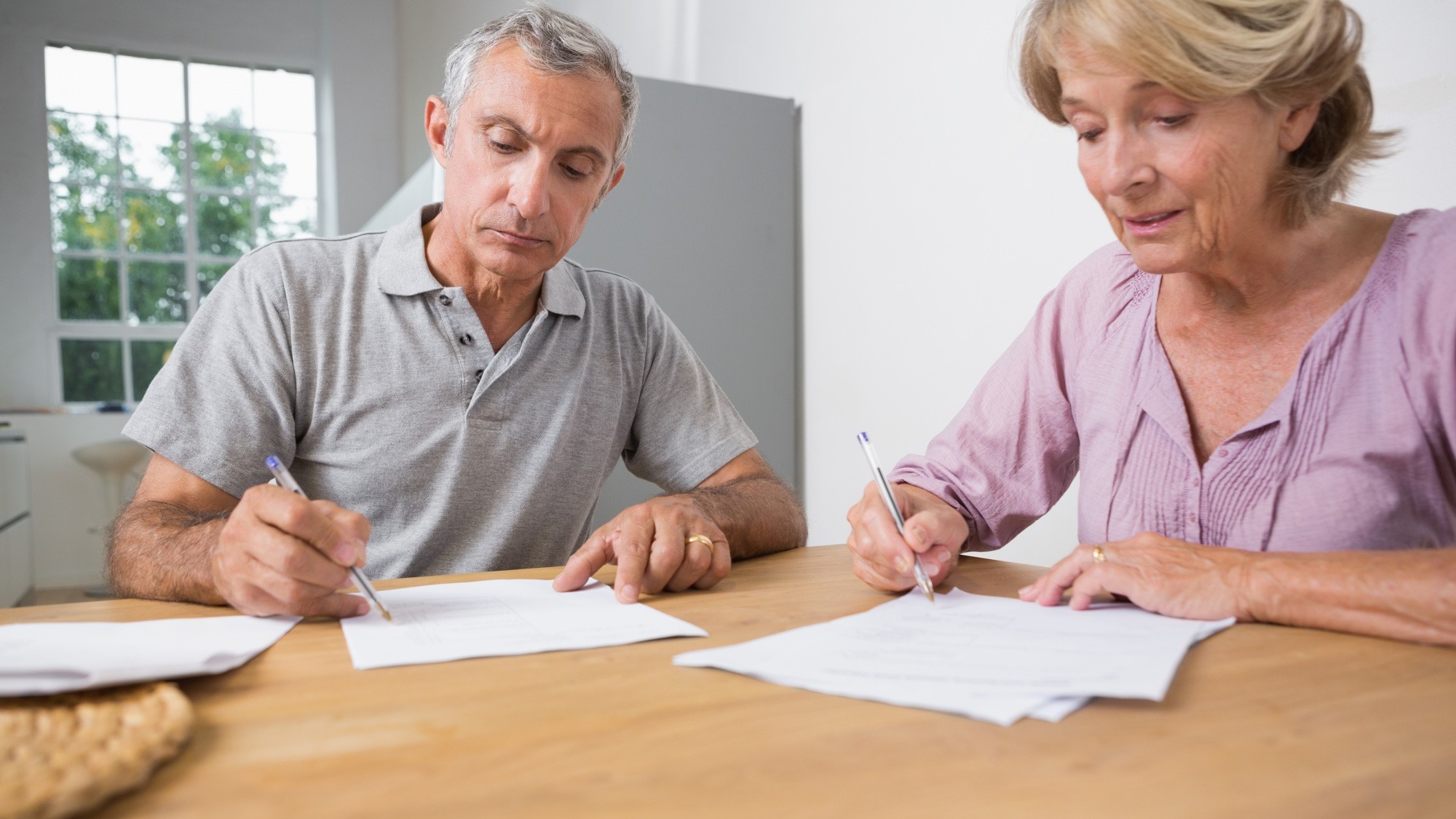 Couple signing documents together