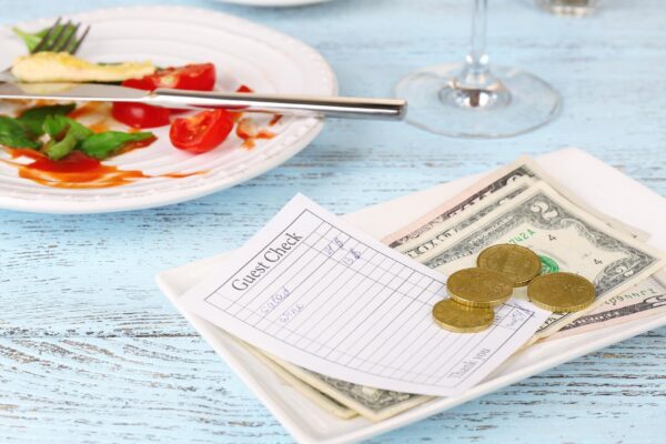 Check and remnants of food on table in restaurant