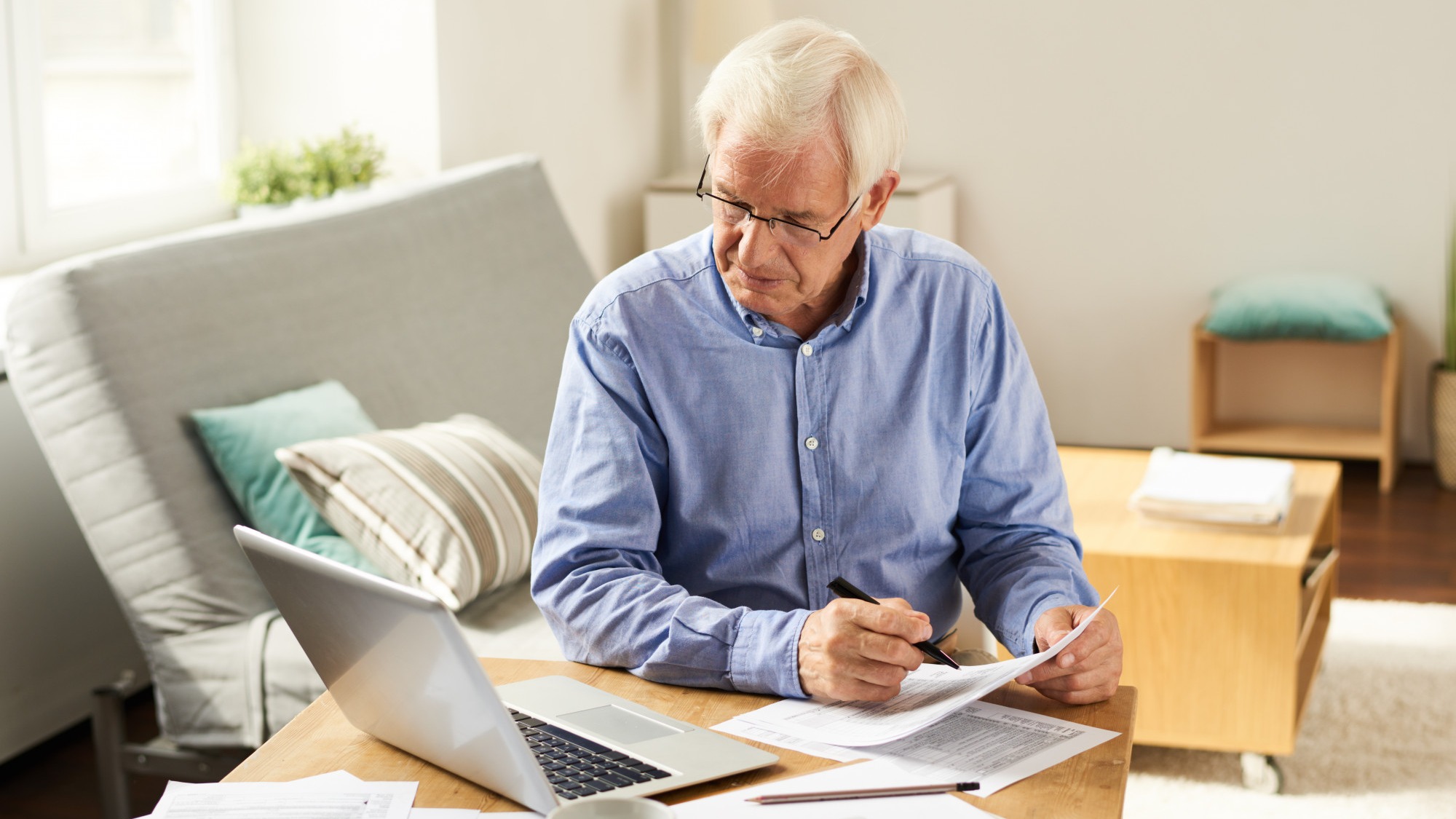 Senior Man Filing Tax Report at Home