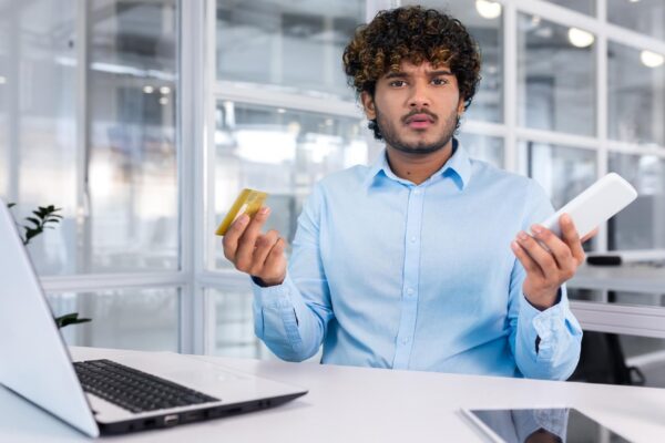 Debt bankruptcy foreclosure fraud a young latin american businessman is sitting in the office at the