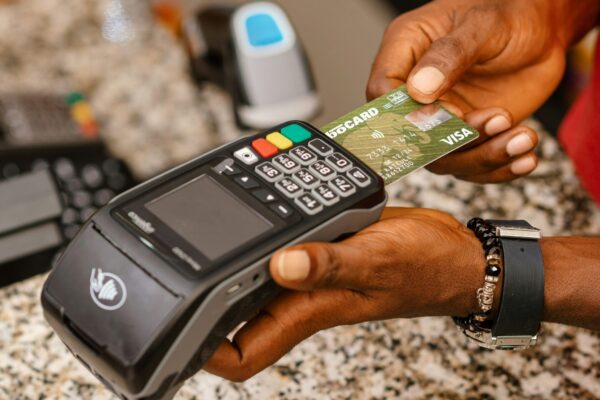 a person holding a credit card in their hand