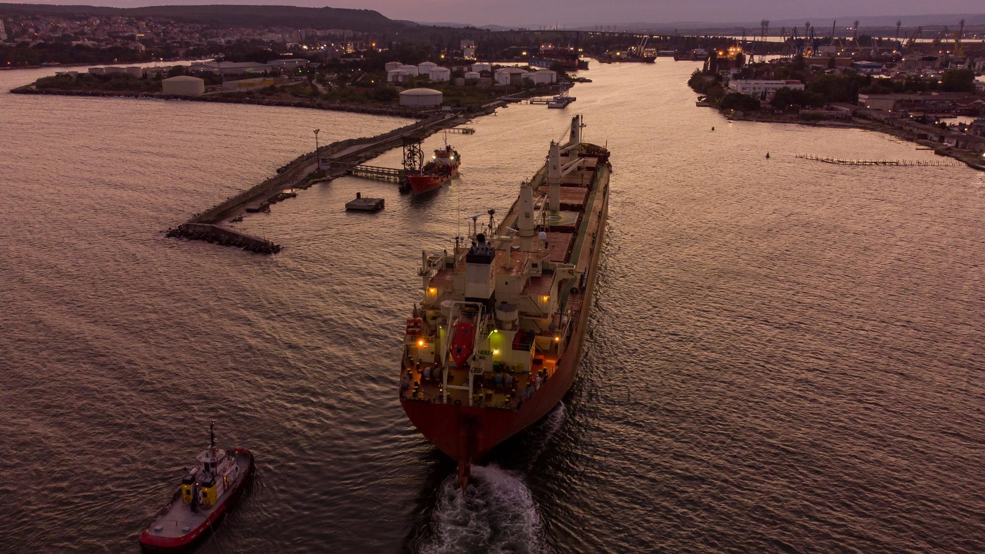 Bulk carrier cargo ship enters the port for unloading in the evening
