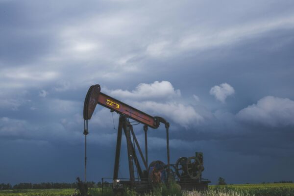 red and black heavy equipment on green grass field under white clouds during daytime
