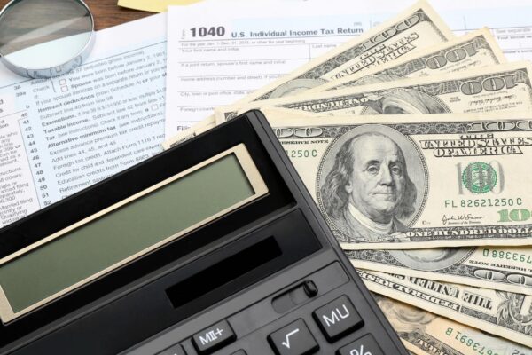 Calculator with money and documents closeup Tax concept