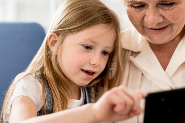Grandmother and girl looking at mobile