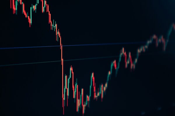 candlestick stock chart on dark screen