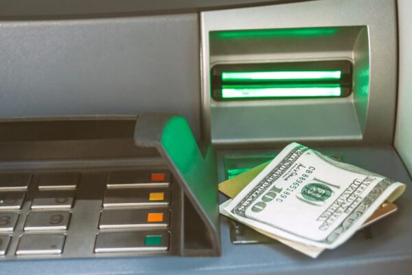 Close-up of money with a bank card lie on the ATM.