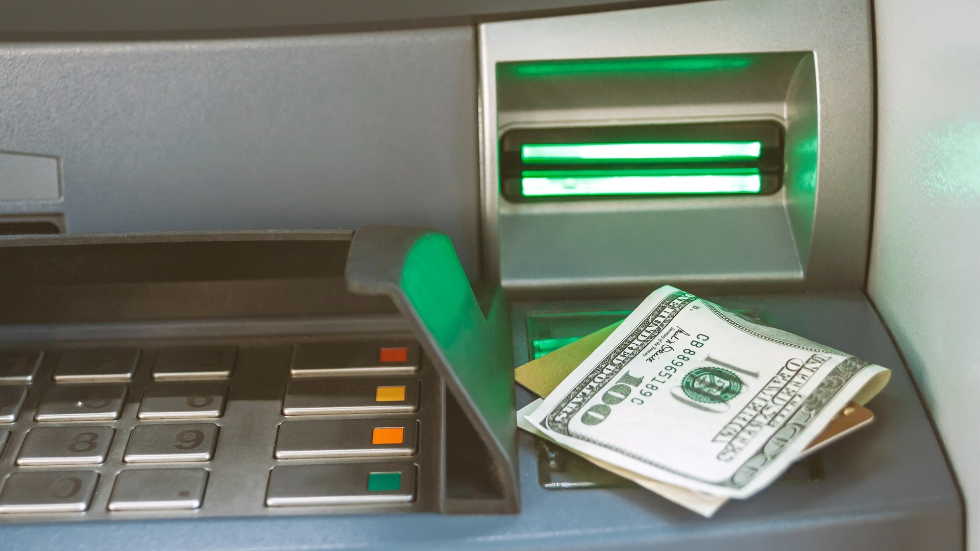 Close-up of money with a bank card lie on the ATM.