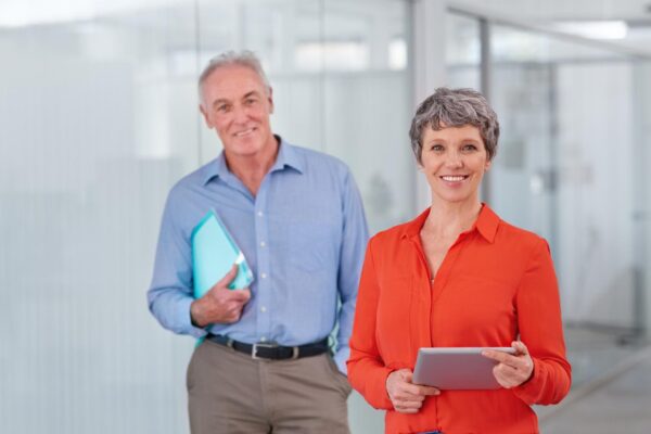 Theyre bringing expert experience to their business Two mature coworkers standing together in the office