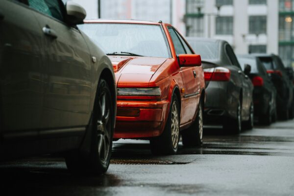 a row of parked cars on a wet street