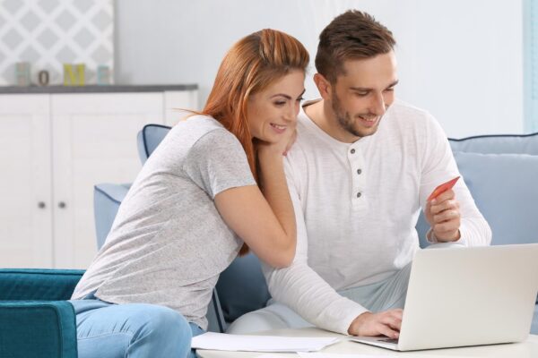 Young couple calculating taxes at home