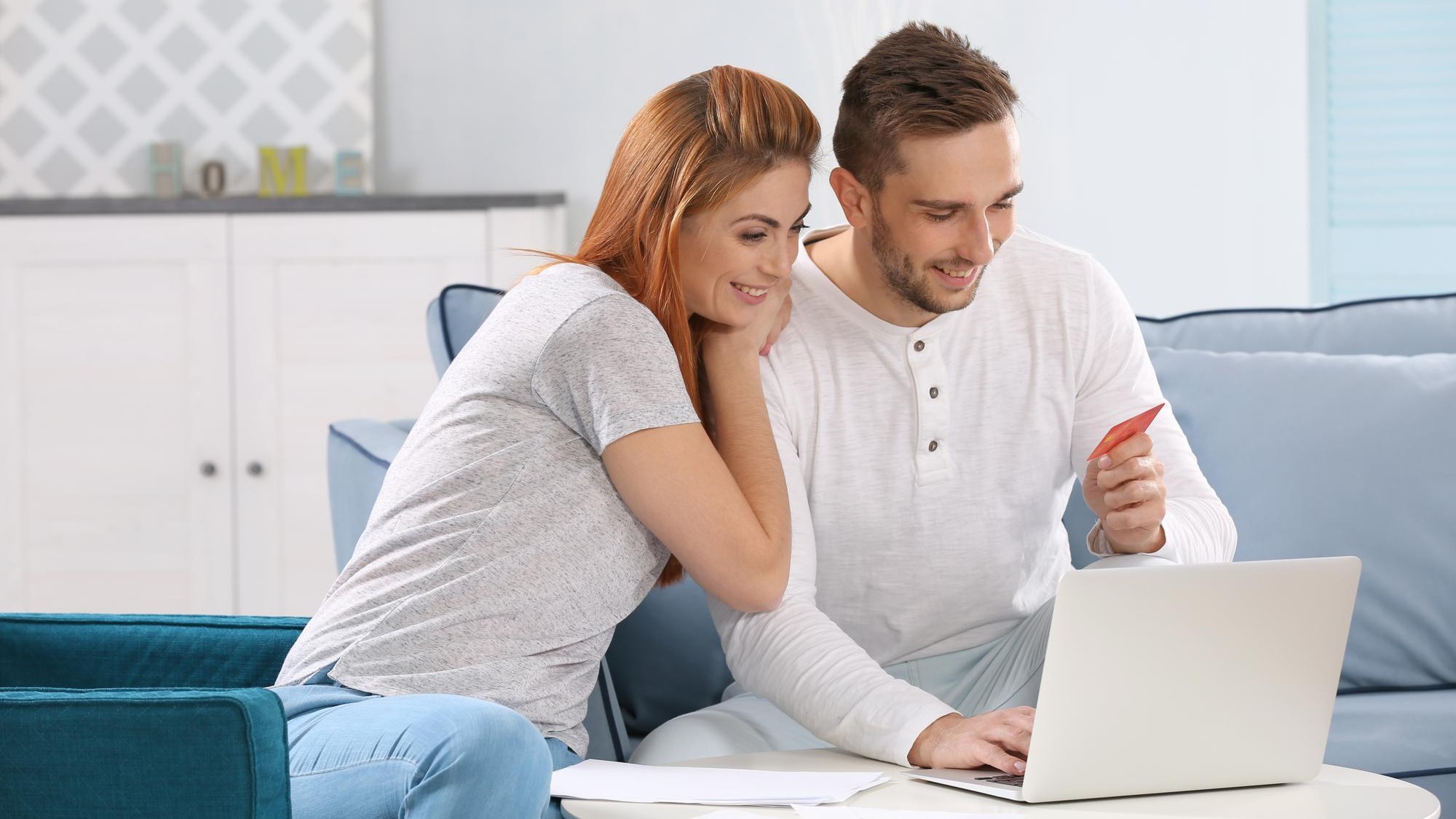 Young couple calculating taxes at home