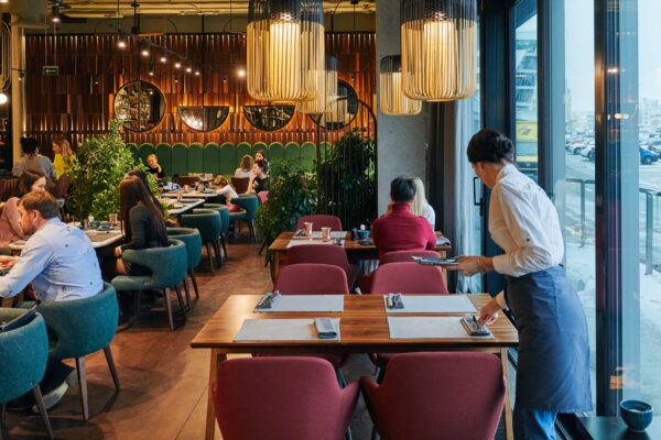 Cozy restaurant with people and waiter