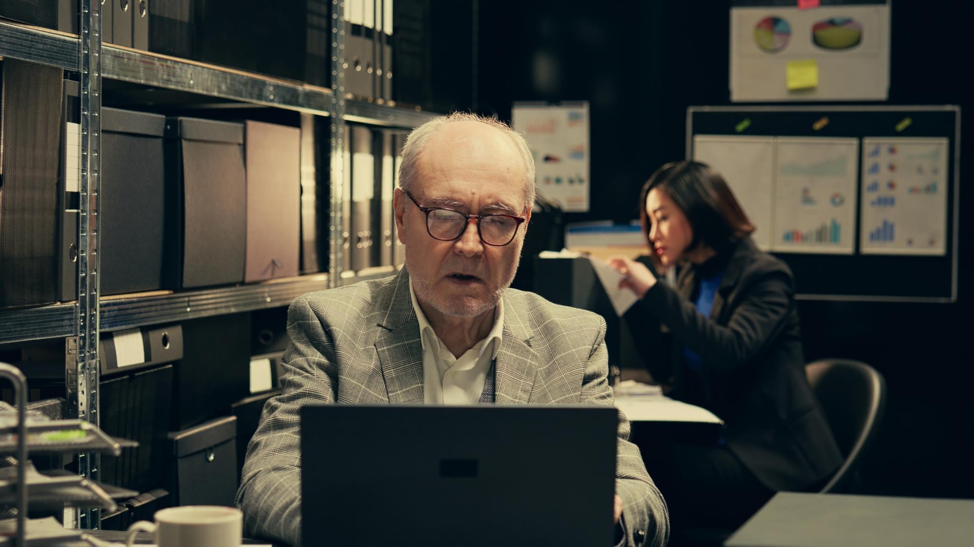 Senior law agent examining financial records to find account information