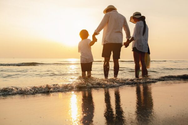 Happy asian family at consisting father motherson and daughter having fun playing beach in summer vacation on the beachHappy family and vacations concept