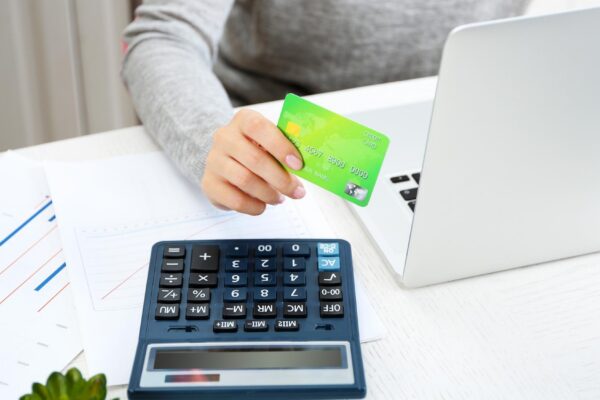Concept for Internet shopping hands with laptop and credit card
