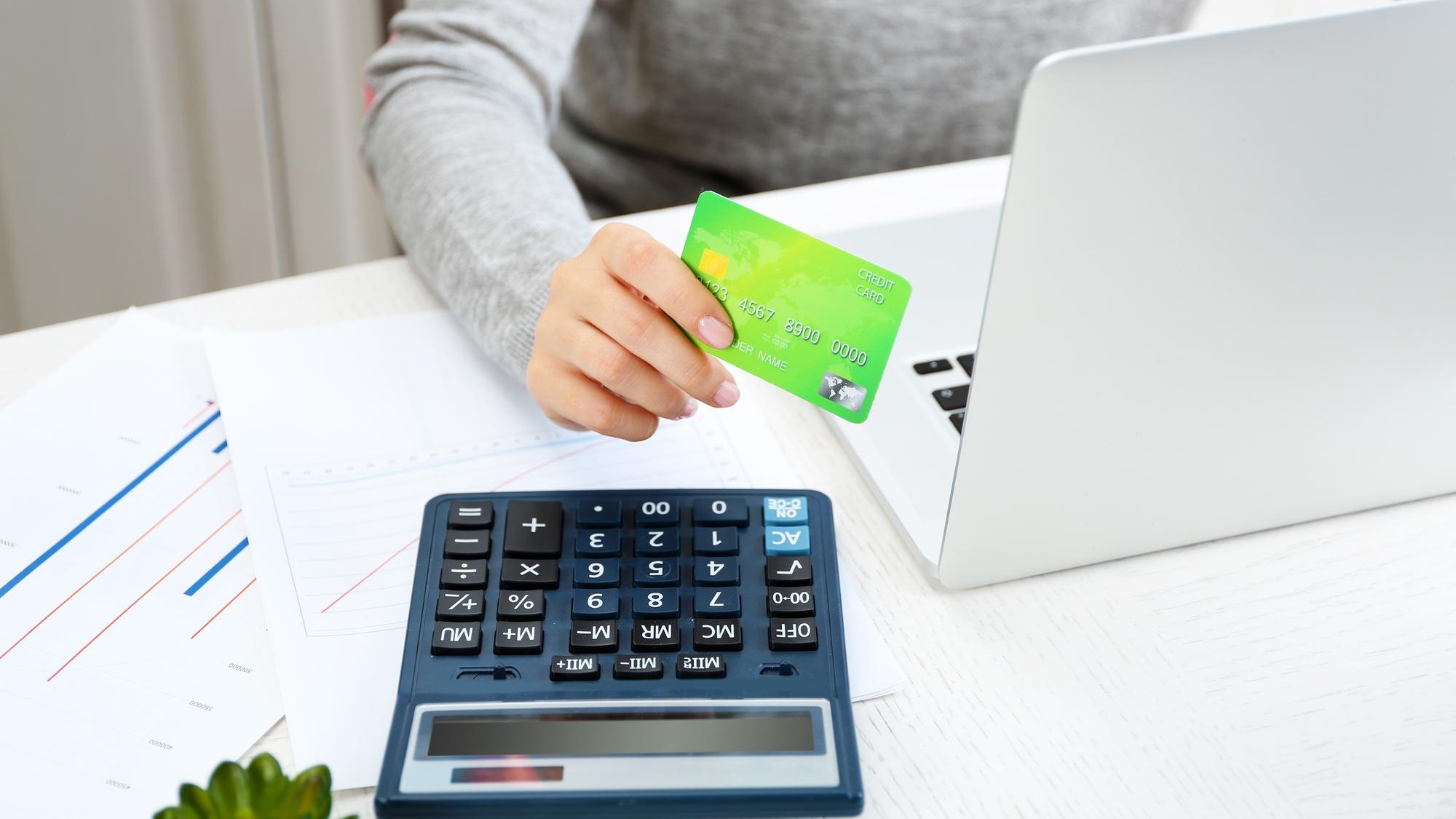Concept for Internet shopping hands with laptop and credit card