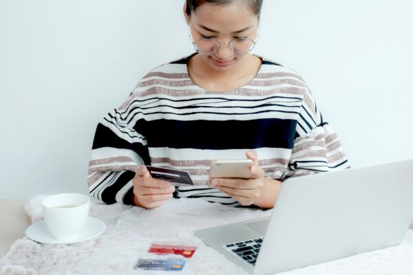 Businesswoman use credit card to online shopping from home, payment e-commerce, internet banking, spending money for next holidays.