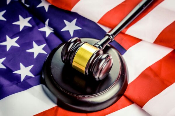 a judge's gavel on top of a flag
