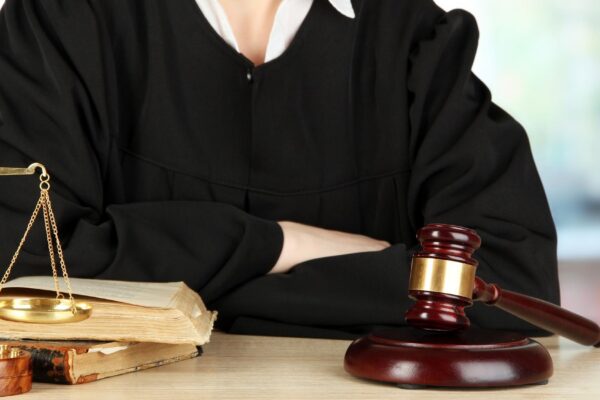 Judge sitting at table during court hearings on room background