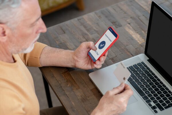 Periodical payments. A man paying in internet using his credit card