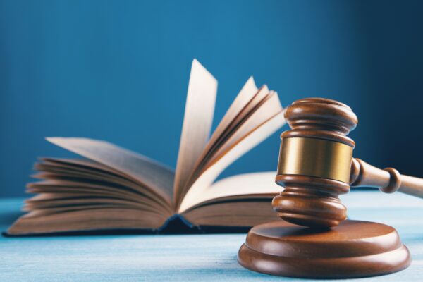 judges gavel and open book on table
