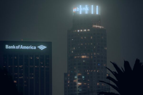 the bank of america building is lit up at night