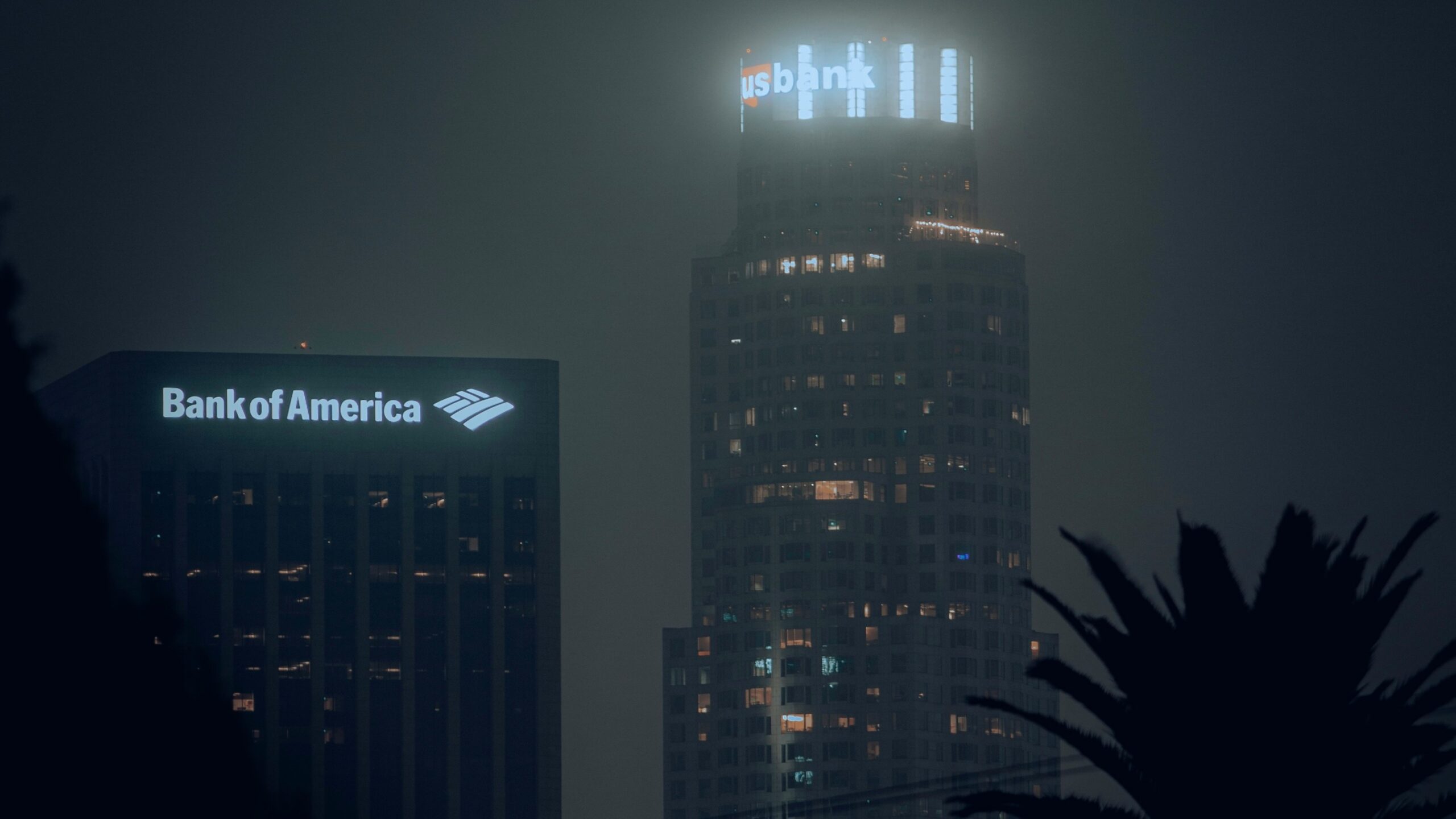 the bank of america building is lit up at night