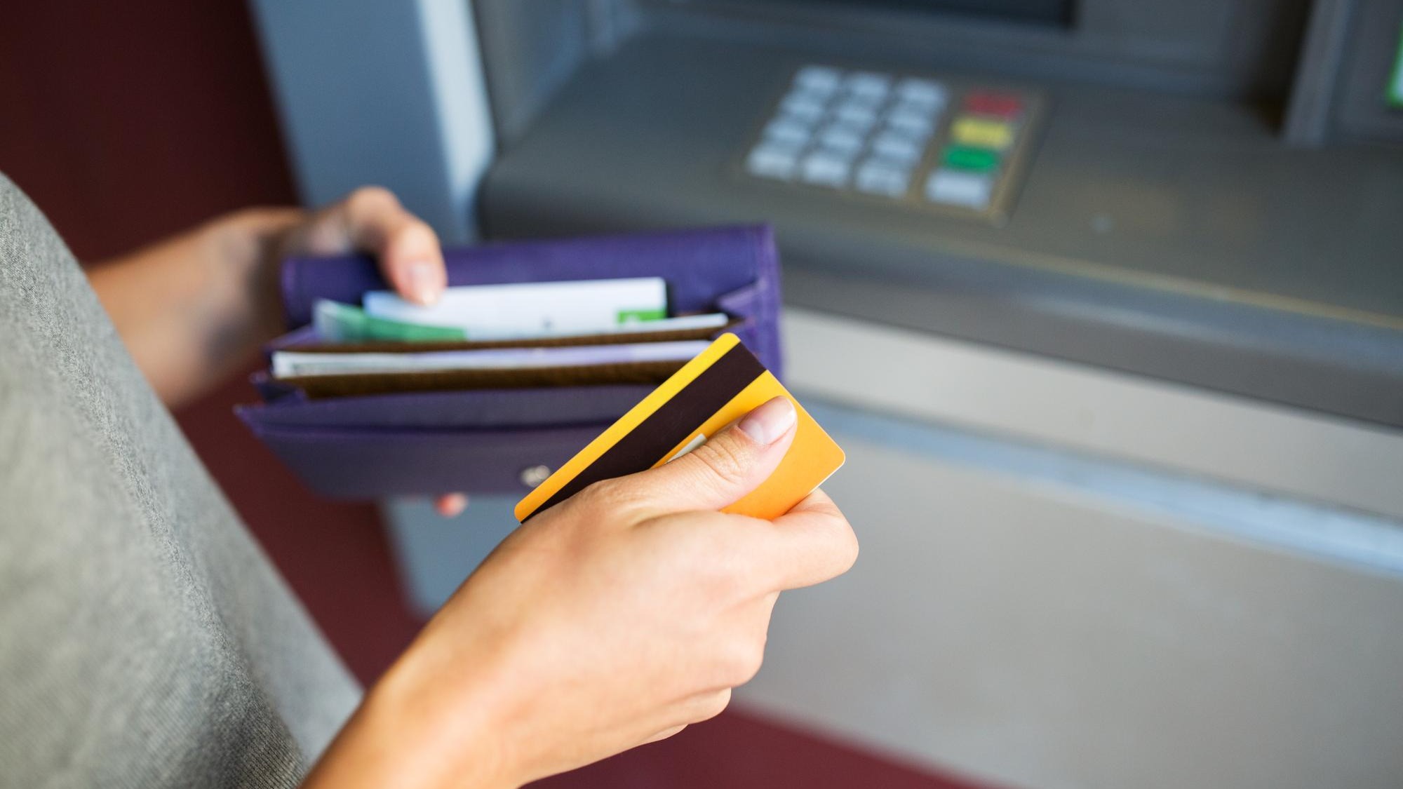 finance, money, bank and people concept - close up of hands with cash and credit card at atm machine