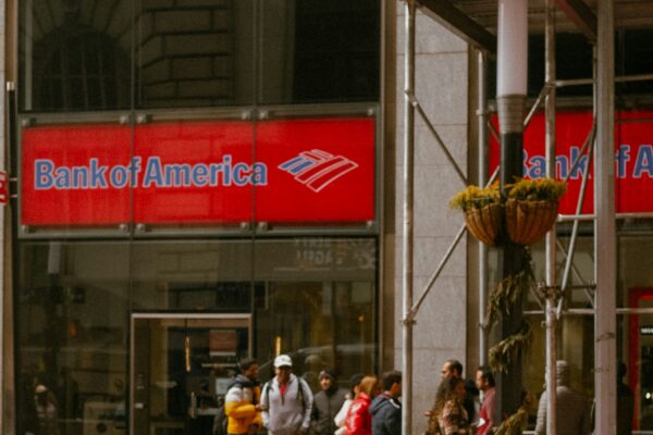 a red sports car is parked in front of a bank of america